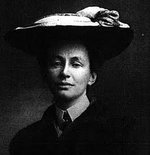 Black and white photo of a handsome woman wearing a large hat.