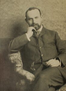 Bearded man in a suit poses for a photo.
