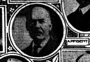 Small photograph of a man clipped from a newspaper.