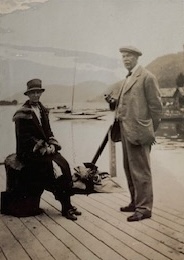 A man and a woman photographed on a dock.