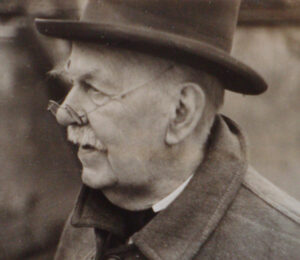 An older man wearing a hat.