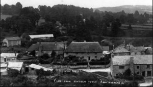 Black and white photograph of the small town--a mix of simple buildings.