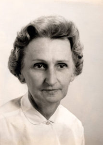 A portrait photograph of an older woman in a white top.