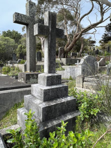 Modern photograph of a stone cross on a plinth. 