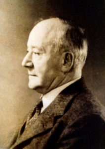 Portrait photo of an older man in profile.
