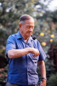 Guy as an older man, smoking a pipe.