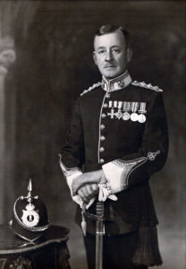 Guy poses in a dress military uniform.