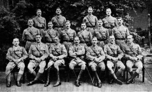 20 or so British officers pose in their uniforms.