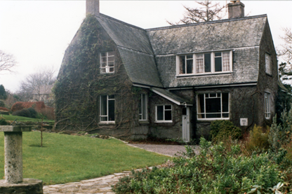Higherfield, a grey country house on an overcast day.