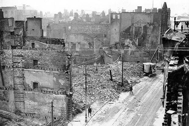 A section of bombed-out city; shells of stone and brick buildings reduced to rubble.