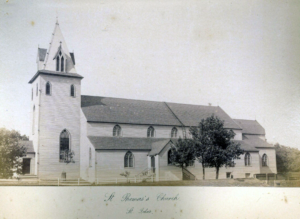 Black and white photograph of a white church with a dark roof.