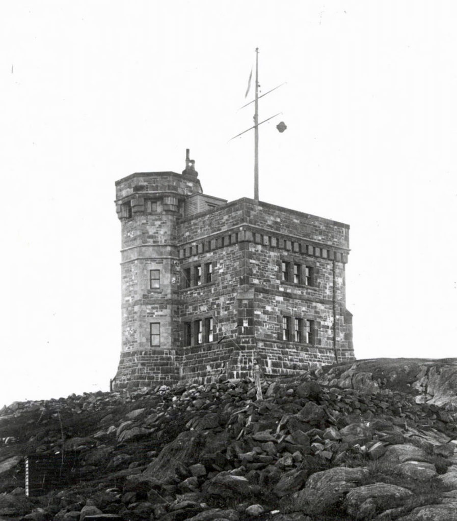 A stone tower that stands several stories tall, built onto a rocky outcrop.