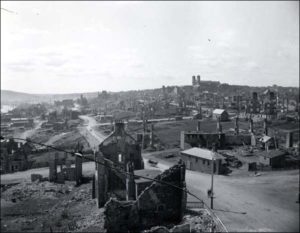 The burned rubble of St. John's after the fire in 1892. The shells of several buildings still stand but little else.