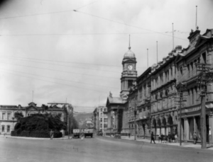 Black and white photograph of an ornate building with a clocktower