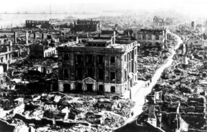 Photo of Tokyo after the Great Kanto Earthquake. Some buildings still stand but many others are rubble.