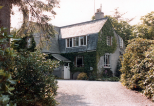 Higherfield, a vine-covered country house with a grey roof
