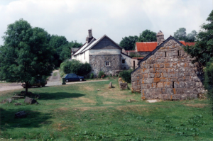 Lettaford Farm, old stone buildings with a 1980s car in frame.