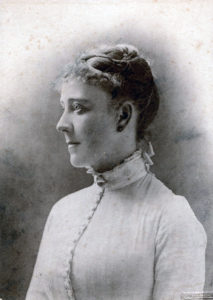 A young woman with delicate features and pinned hair.
