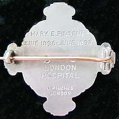 The back of a decorative broach. It is silver and engraved Mary E. Pinsent June 1896 - June 1898 London Hospital
