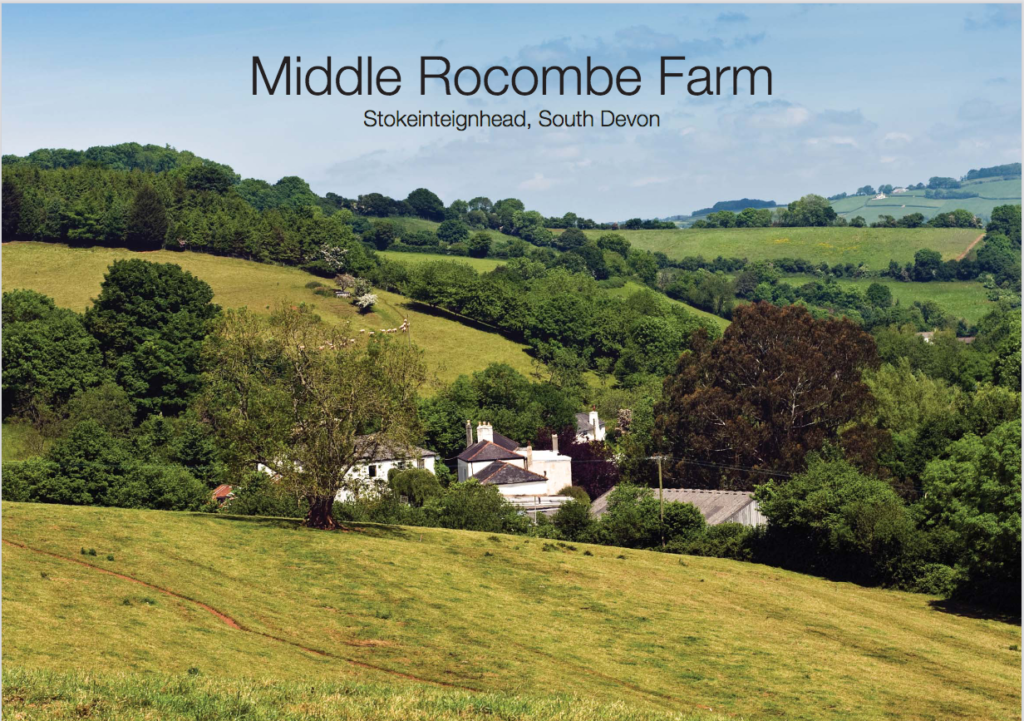 Colour photo of a small cluster of farm buildings amid rolling fields. Reads Middle Rocombe Farm.