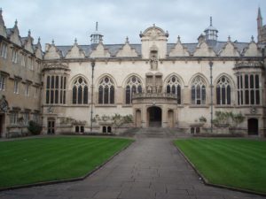 An ornate grey building with stained glace windows.