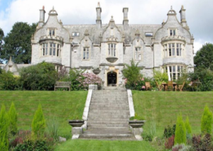 A stately white mansion on a hill.