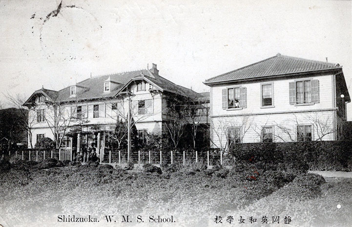 A faded postcard of two buildings in Japan, circa 1900.