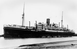 A black and white photograph of a massive steam ship.