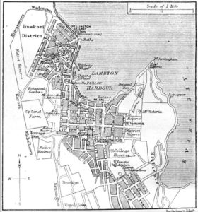 Black and white map showing the city of Wellington curled around Lambton Harbour.