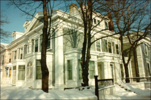 Modern photograph of a handsome multistory white and grey Victorian building