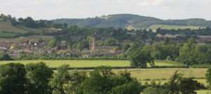 Modern photograph of a landscape with a handsome stone church in the center.