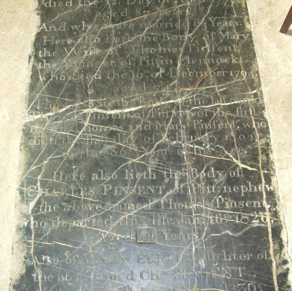 Flat stone memorial embedded in the church floor.