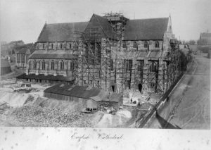 A stone cathedral surrounded by scaffolding, seemingly under construction.