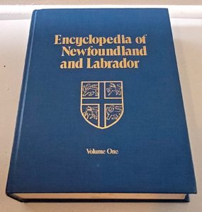 A photograph of a book with a blue cover. It is titled Encyclopedia of Newfoundland and Labrador, Volume 1.