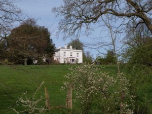 A white building atop a hill.